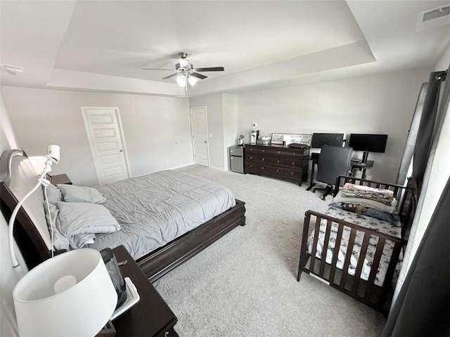 769 Humphry Dr, Winder, GA 30680 - carpeted bedroom with a raised ceiling, ceiling fan, a desk, and baseboards