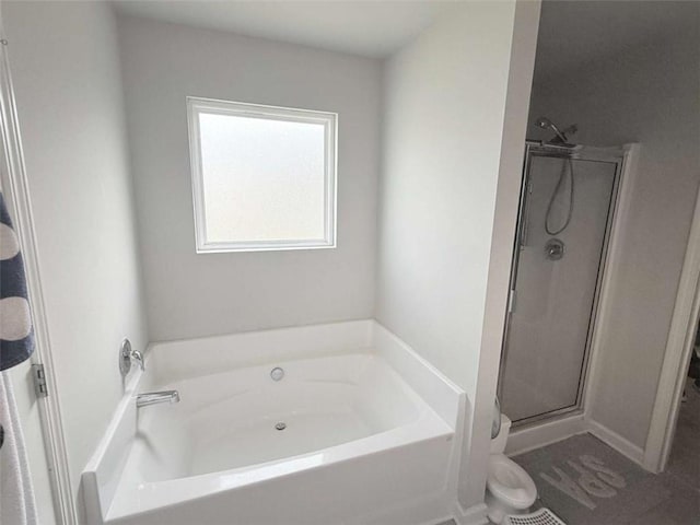 769 Humphry Dr, Winder, GA 30680 - full bathroom with a garden tub, a stall shower, and toilet