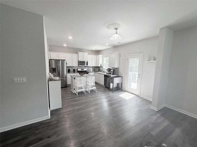 769 Humphry Dr, Winder, GA 30680 - kitchen with stainless steel appliances, white cabinetry, baseboards, dark wood finished floors, and recessed lighting