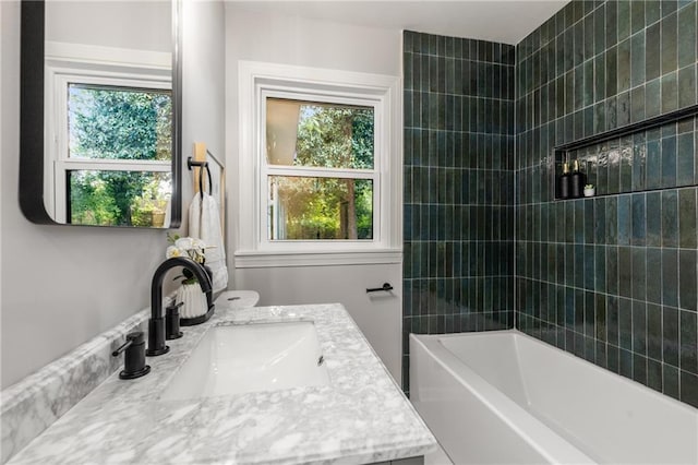 bathroom with bathtub / shower combination and vanity