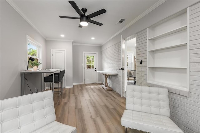 interior space with ceiling fan, recessed lighting, baseboards, wood finished floors, and ornamental molding