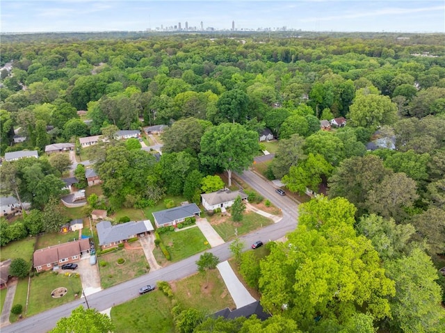 birds eye view of property featuring a view of trees
