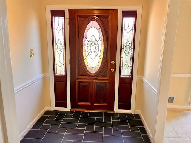 entrance foyer with plenty of natural light, visible vents, and baseboards