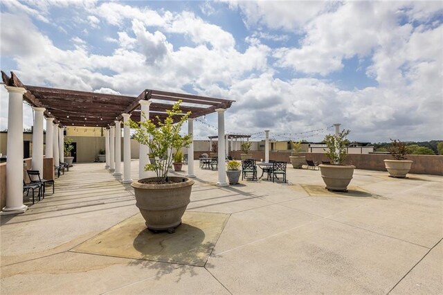 5300 Peachtree Rd Unit 3206, Atlanta, GA 30341 - view of patio / terrace with a pergola, fence, and outdoor dining area