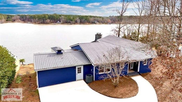 137 Rockville Springs Ct, Eatonton, GA 31024 - view of front of home featuring a porch, a chimney, metal roof, central AC, and a water view