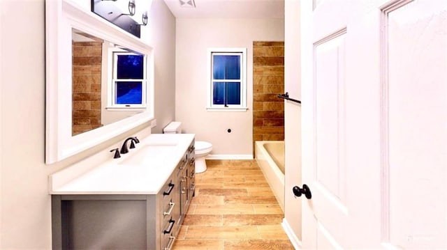 137 Rockville Springs Ct, Eatonton, GA 31024 - bathroom with toilet, baseboards, wood finished floors, and vanity