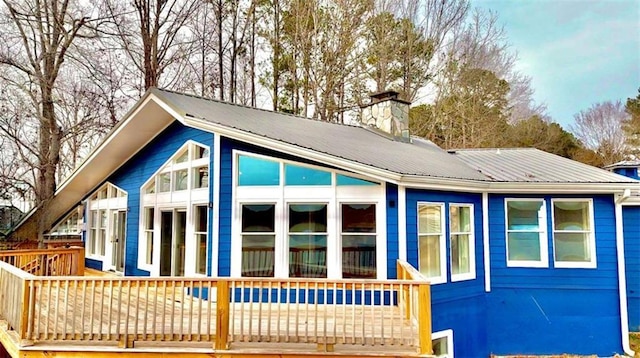 137 Rockville Springs Ct, Eatonton, GA 31024 - exterior space featuring a deck, metal roof, and a chimney