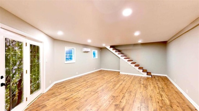 137 Rockville Springs Ct, Eatonton, GA 31024 - below grade area with recessed lighting, light wood finished floors, a wall unit AC, and stairs