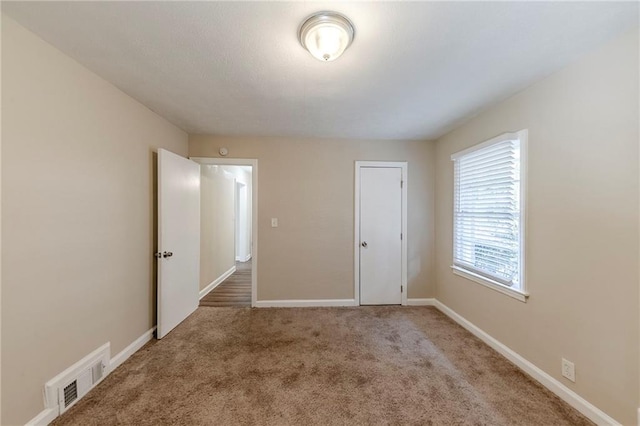 unfurnished bedroom featuring light carpet