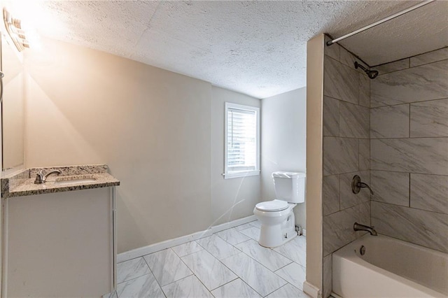 full bathroom with tiled shower / bath, vanity, toilet, and a textured ceiling