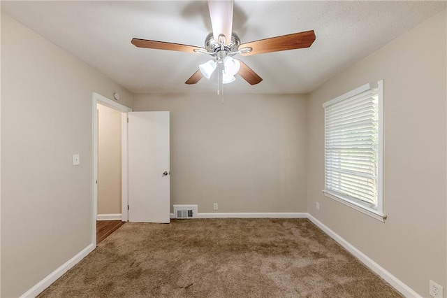 empty room with carpet and ceiling fan