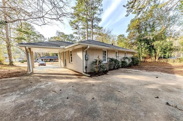 view of side of home with a carport