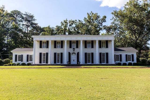 neoclassical / greek revival house with a front lawn