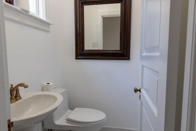 half bathroom with a sink and toilet