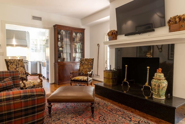 sitting room with a premium fireplace and visible vents