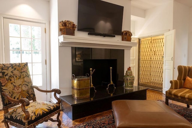 living area with a tiled fireplace