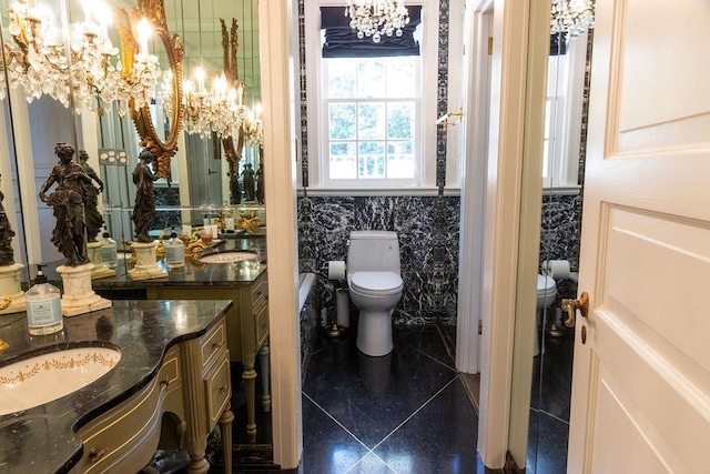 full bath featuring toilet, tile patterned floors, a chandelier, and vanity