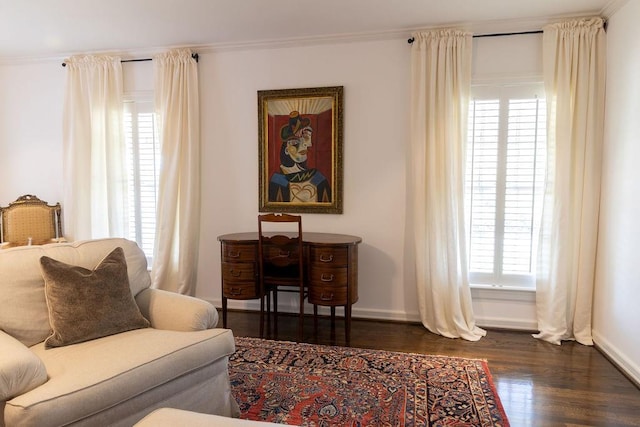 sitting room featuring crown molding, baseboards, and dark wood-type flooring