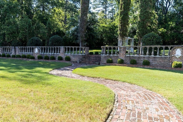 view of home's community featuring a yard and fence