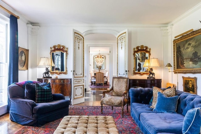 living area featuring a chandelier, parquet floors, and crown molding