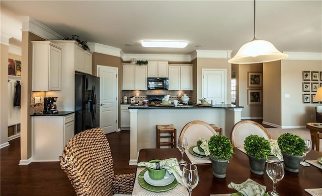 5268 Mulberry Pass Ct, Hoschton, GA 30548 - kitchen with black appliances, dark countertops, decorative backsplash, hanging light fixtures, and crown molding