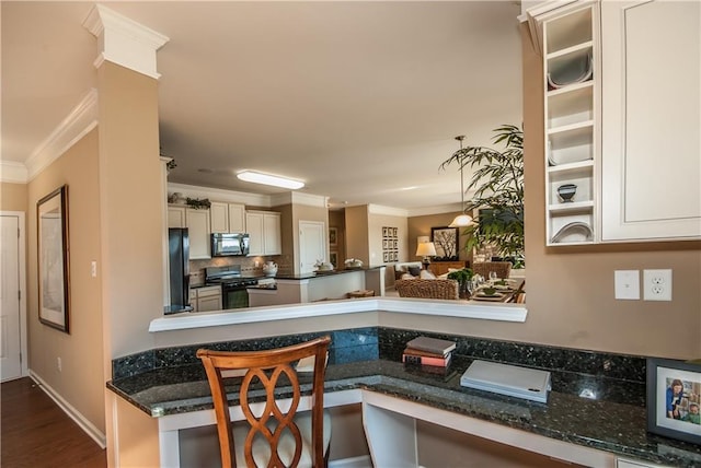 5268 Mulberry Pass Ct, Hoschton, GA 30548 - kitchen featuring black appliances, ornamental molding, tasteful backsplash, dark wood-style flooring, and dark stone countertops