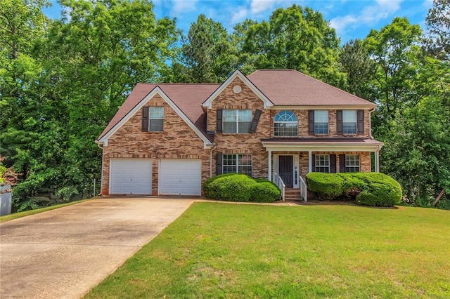 11354 Conner Ct, Hampton, GA 30228 - view of front of home with driveway, an attached garage, a front yard, and brick siding