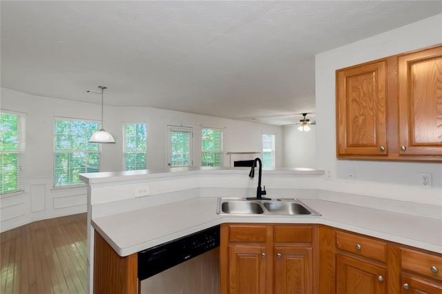 11354 Conner Ct, Hampton, GA 30228 - kitchen with dishwasher, a peninsula, brown cabinetry, light countertops, and plenty of natural light