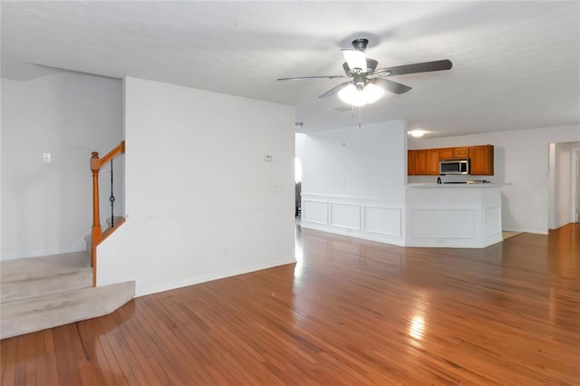 11354 Conner Ct, Hampton, GA 30228 - unfurnished living room featuring stairs, light wood-type flooring, and a ceiling fan