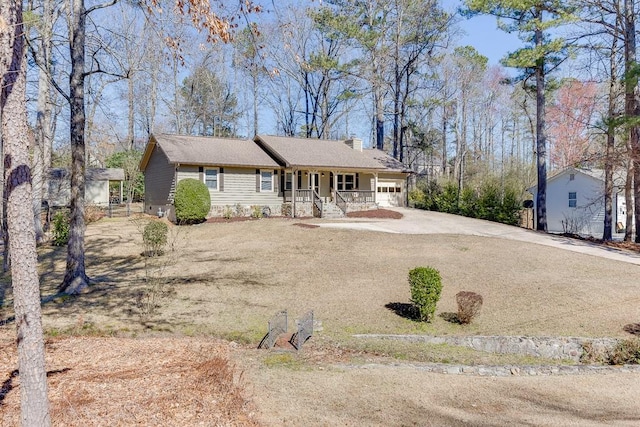 single story home with a garage, a chimney, a porch, and concrete driveway