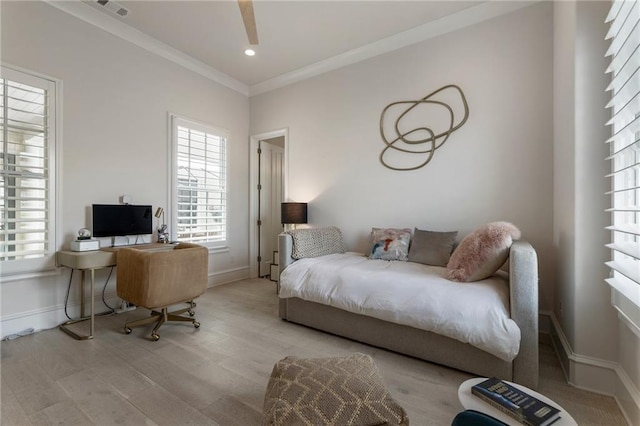 bedroom featuring baseboards, ornamental molding, wood finished floors, and visible vents