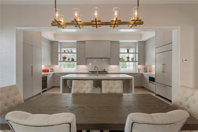 kitchen with a sink, gray cabinetry, modern cabinets, and wine cooler