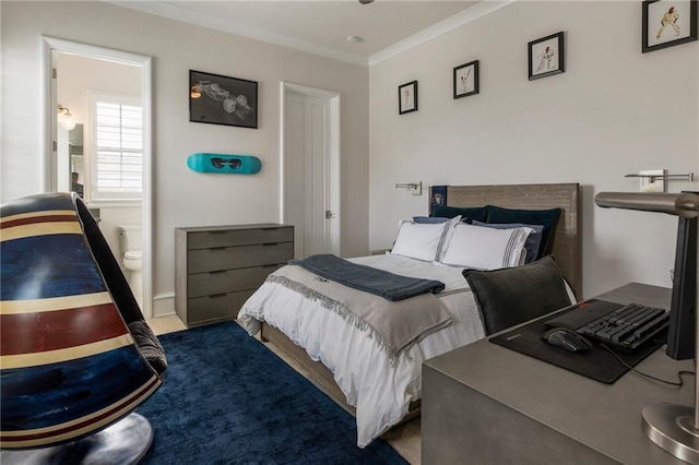 bedroom with crown molding and connected bathroom