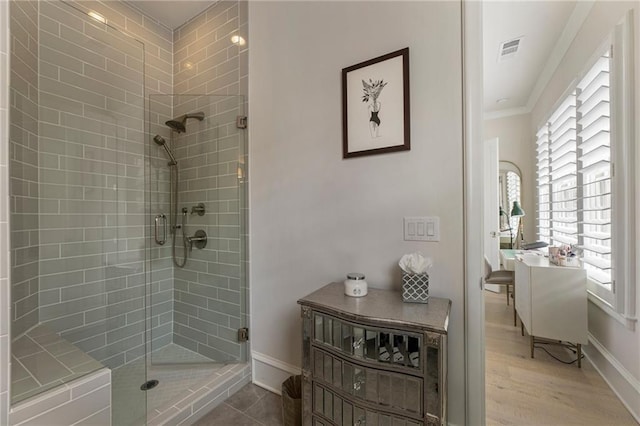 bathroom featuring visible vents, baseboards, a stall shower, and a healthy amount of sunlight