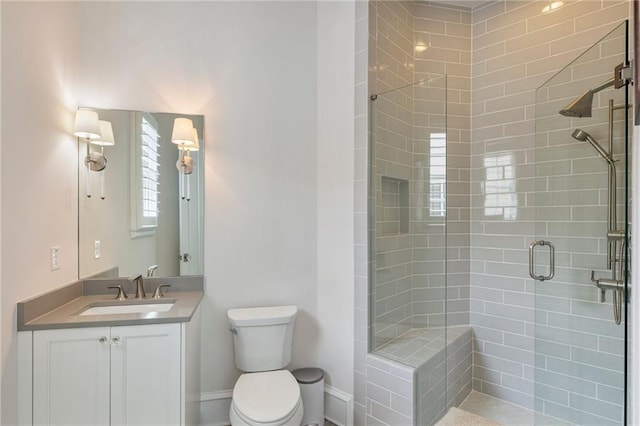full bathroom with vanity, a stall shower, and toilet