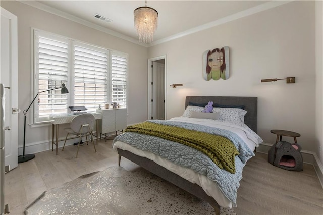 bedroom with crown molding, baseboards, visible vents, and wood finished floors