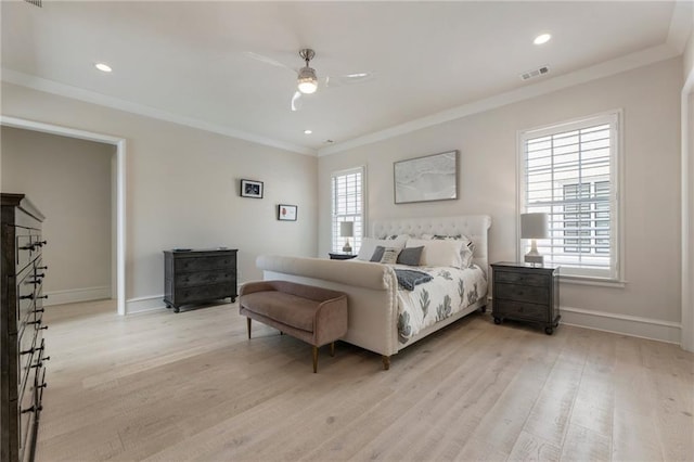 bedroom with visible vents, ornamental molding, baseboards, a ceiling fan, and light wood-style flooring