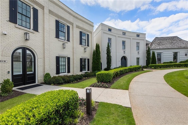 exterior space featuring french doors and brick siding