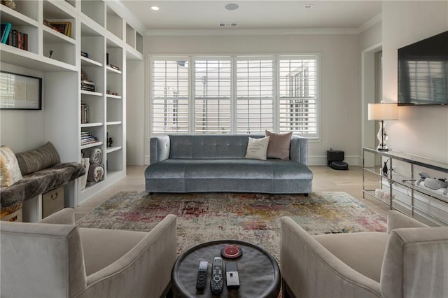 living room featuring crown molding, visible vents, a wealth of natural light, and wood finished floors