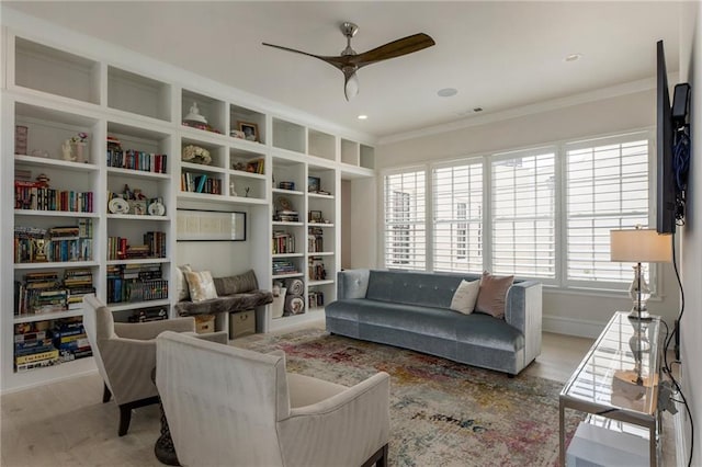 sitting room featuring crown molding, a ceiling fan, wood finished floors, and visible vents