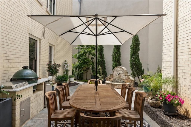 view of patio / terrace with an outdoor kitchen and outdoor dining area