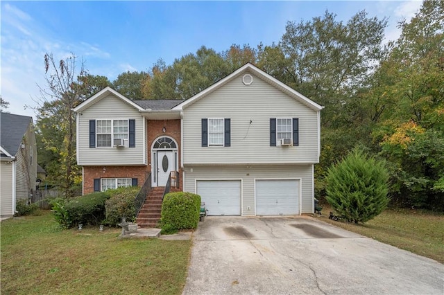 split foyer home featuring a garage and a front lawn