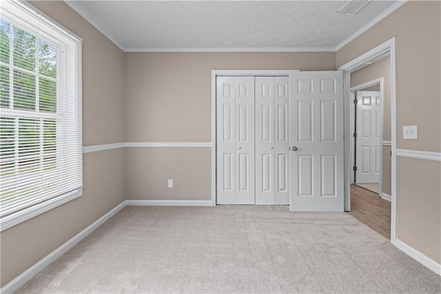 356 Chardonnay Trce, Braselton, GA 30517 - unfurnished bedroom featuring carpet flooring, ornamental molding, a closet, and a textured ceiling