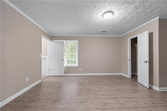 356 Chardonnay Trce, Braselton, GA 30517 - spare room with wood finished floors, a textured ceiling, and crown molding