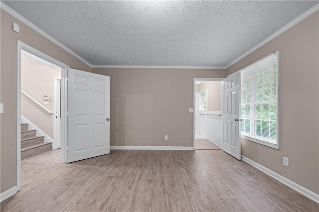 356 Chardonnay Trce, Braselton, GA 30517 - unfurnished room featuring wood finished floors, a textured ceiling, ornamental molding, and stairway