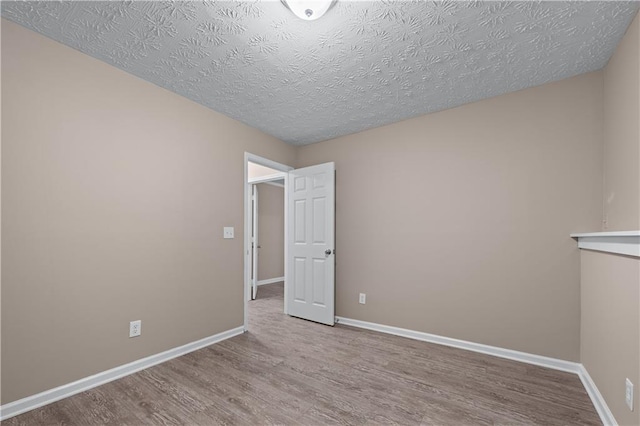 356 Chardonnay Trce, Braselton, GA 30517 - empty room with wood finished floors and a textured ceiling