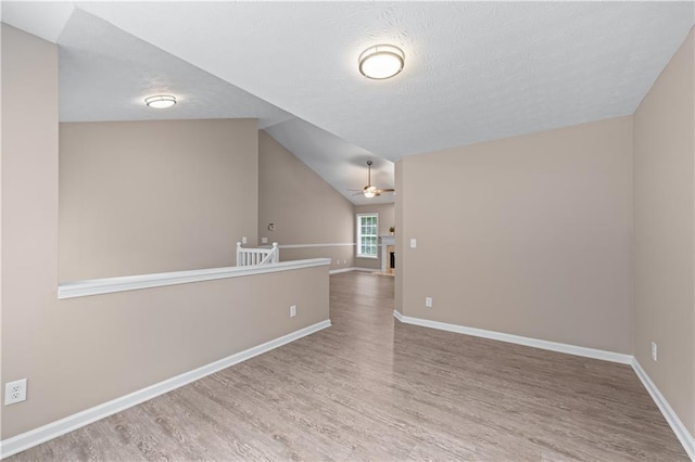 356 Chardonnay Trce, Braselton, GA 30517 - spare room featuring a ceiling fan, wood finished floors, a textured ceiling, and lofted ceiling