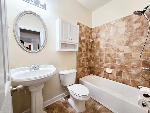 full bath with baseboards, tub / shower combination, and toilet