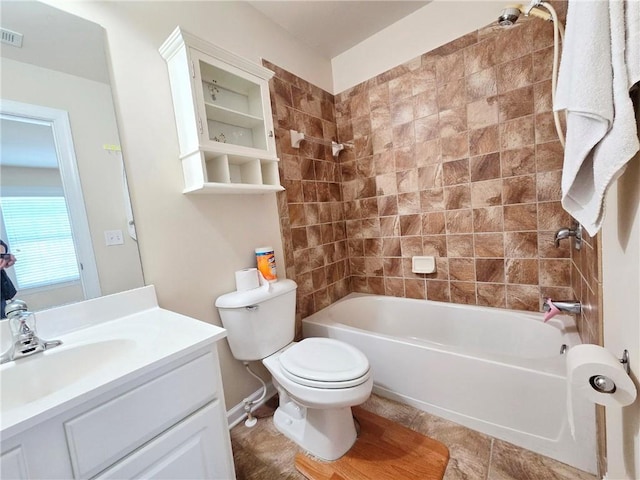 full bathroom featuring toilet, vanity, visible vents, and shower / bathing tub combination