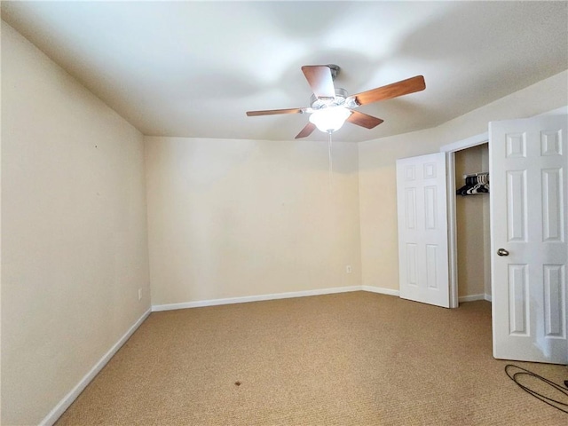 unfurnished bedroom with carpet floors, a ceiling fan, and baseboards